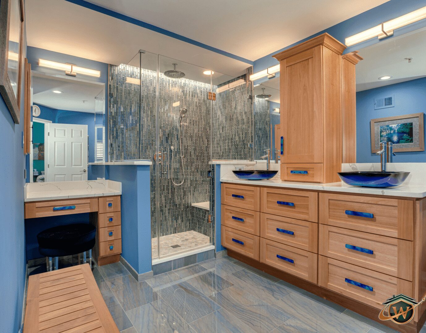 Luxurious blue bathroom with glass shower.
